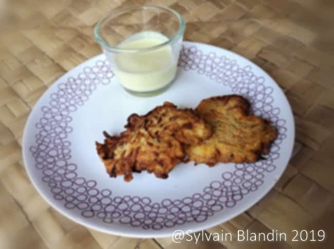 Galettes de légumes dorées servies avec une sauce yaourt fraîche et citronnée.
